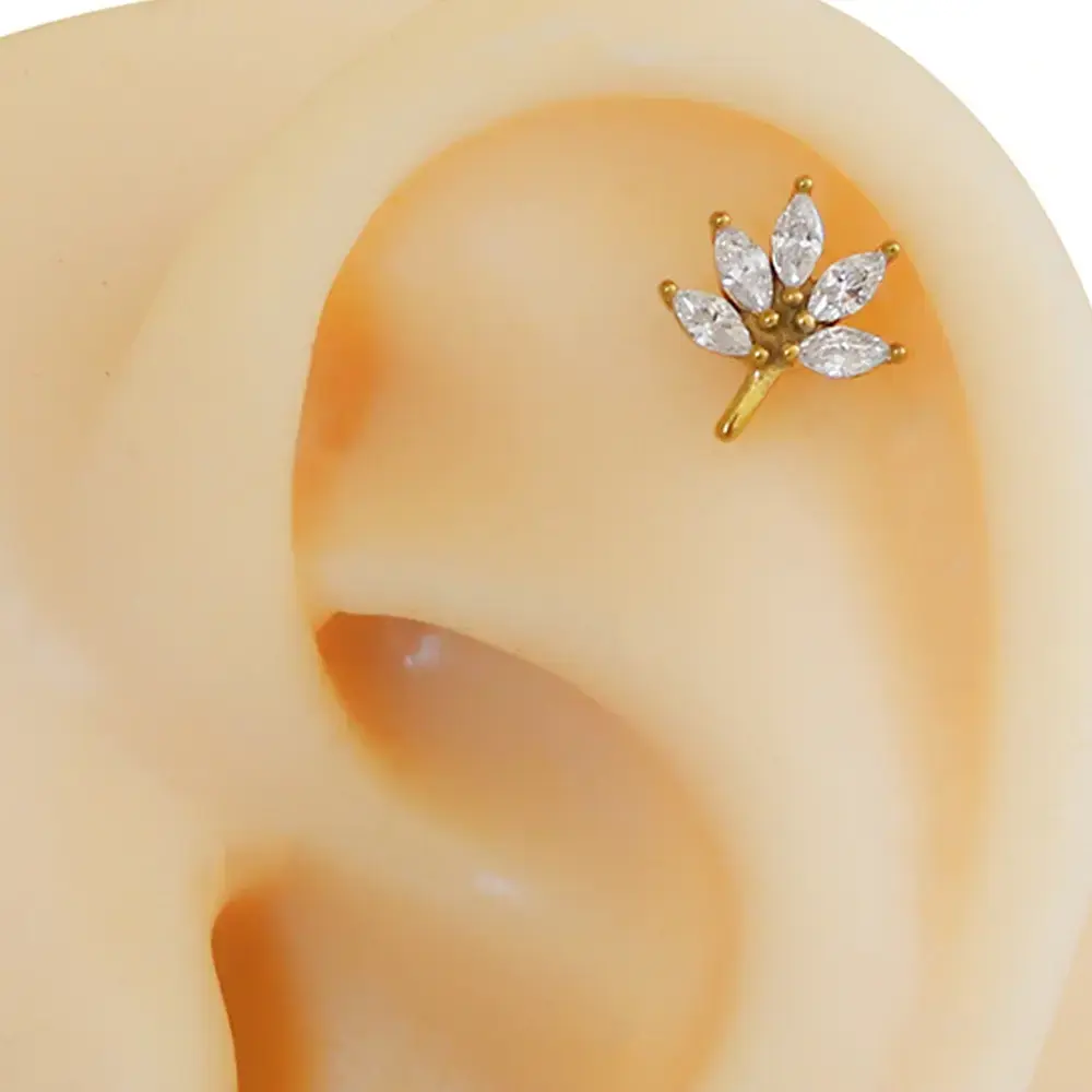 gold-zirkon-tasli-cicek-isiltisi-tragus-helix-kikirdak-piercing