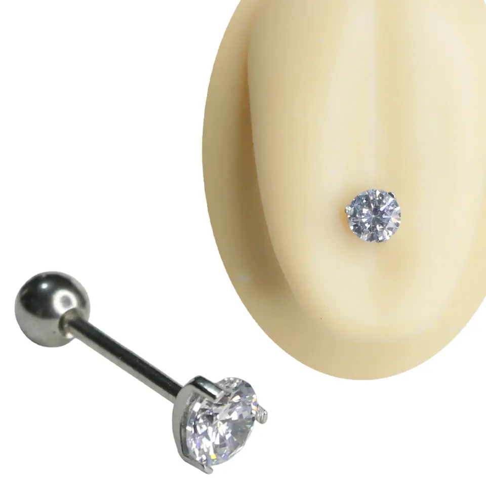 Gümüş renkli cerrahi çelikten üretilmiş, yuvarlak kesim şeffaf zirkon taşlı dil piercingi ve 1,6 mm x 16 mm dil barının görünümü.