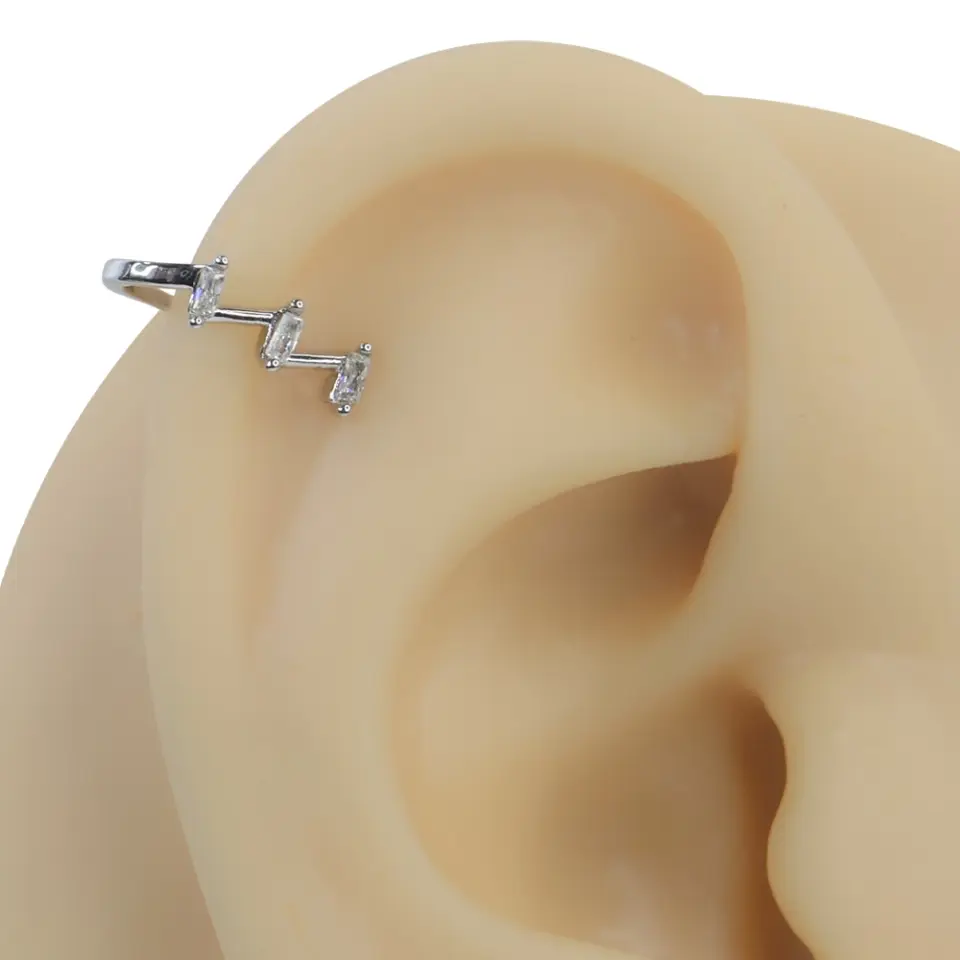 Gümüş rengi ışık basamakları zirkon taşlı sıkıştırma kıkırdak piercing modelinin kulak üzerindeki parıltılı ve lüks duruşu