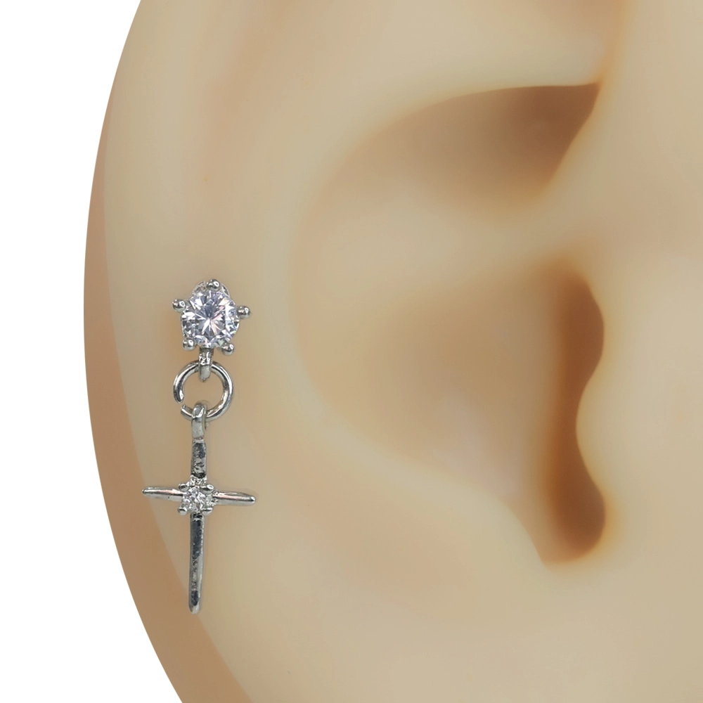 Kulak üzerinde sergilenen sallantılı haç figürlü zirkon taşlı gümüş renk tragus helix kıkırdak piercing