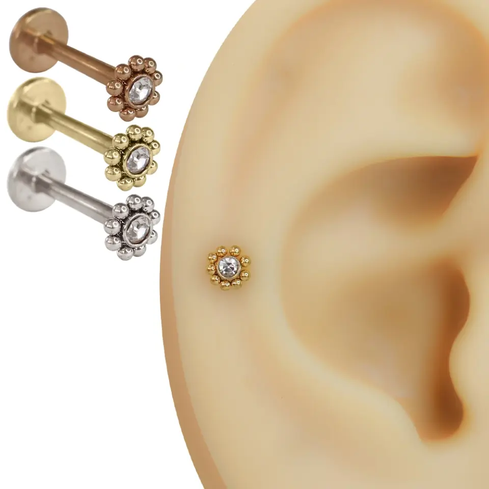 Orta kısmında şeffaf zirkon taş yer alan çiçek tasarımlı rose, gümüş ve sarı flatback piercing modelleri
