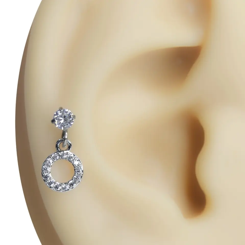 Kulak üzerinde sergilenen sallantılı halka figürlü zirkon taşlı tragus helix kıkırdak piercing