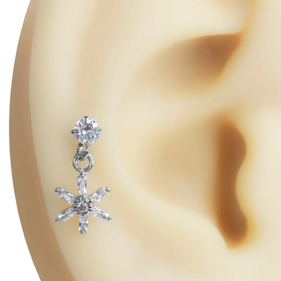 Kulak kıkırdağı üzerinde sergilenen zirkon taşlı çiçek figürlü tragus helix kıkırdak piercing